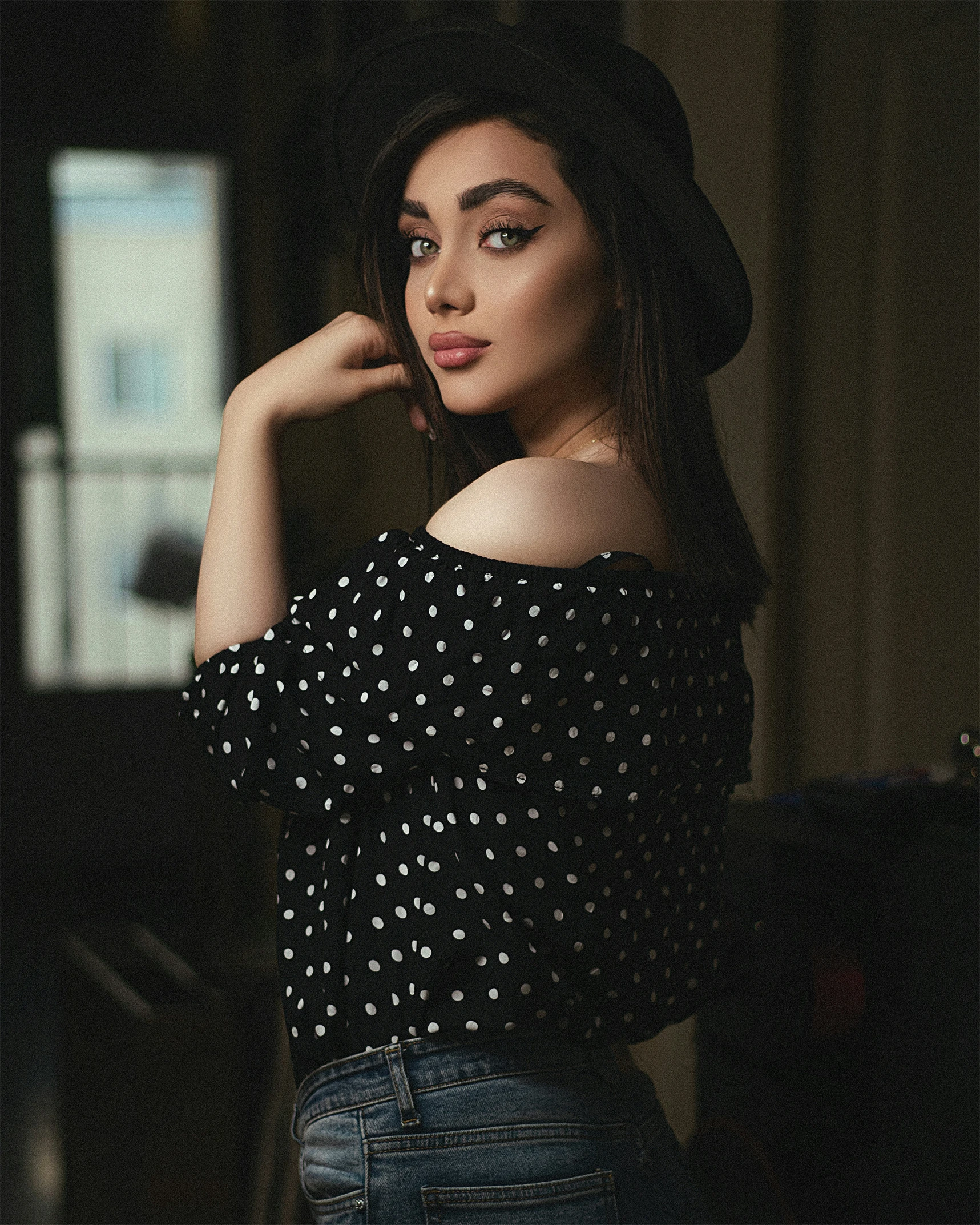 woman posing in a room with dark background