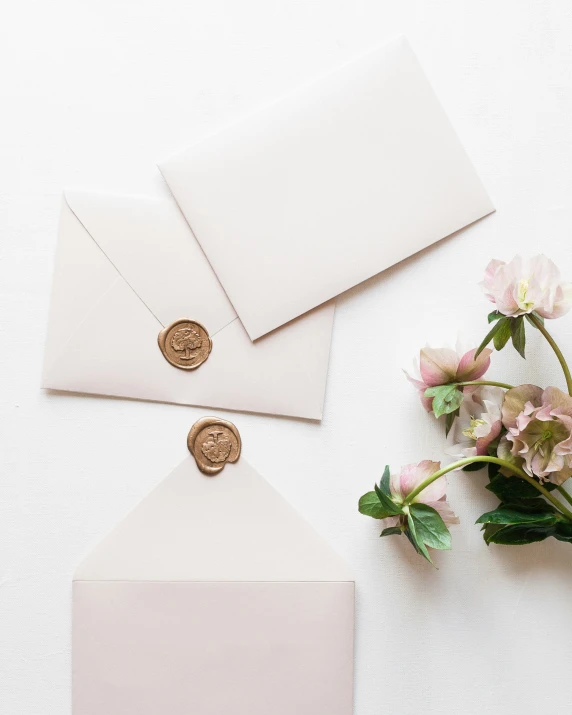 a couple of white envelopes that are sitting on a table