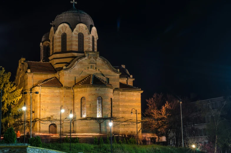 an old church at night with the lights on