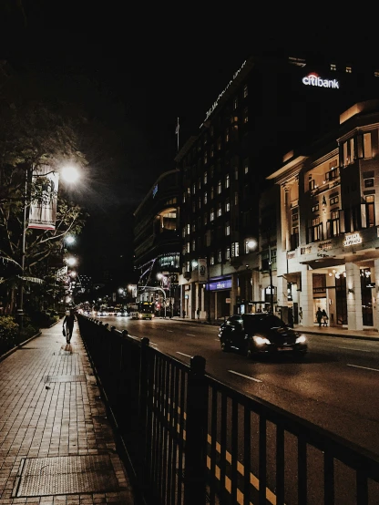 a city street is lit at night in the dark