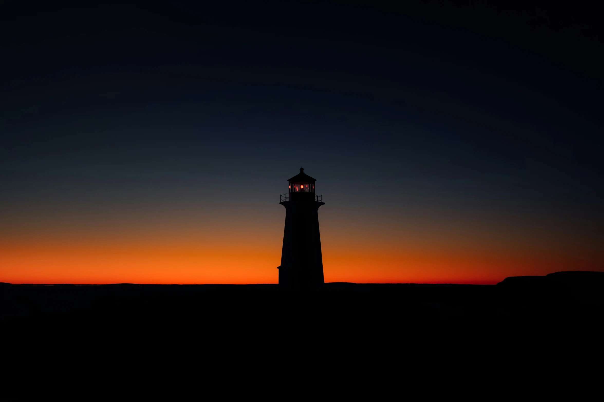 a tall clock tower next to the ocean