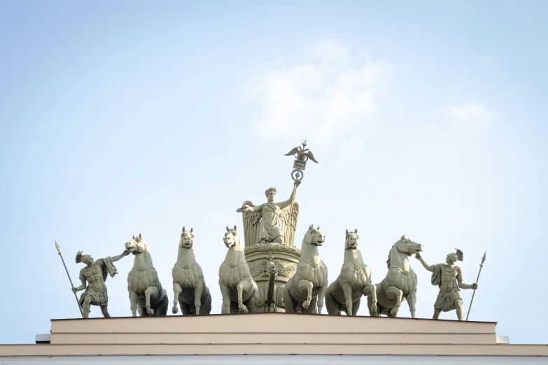 many statues with a bird and a blue sky