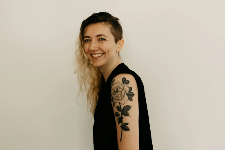 a woman with a rose tattoo on her arm