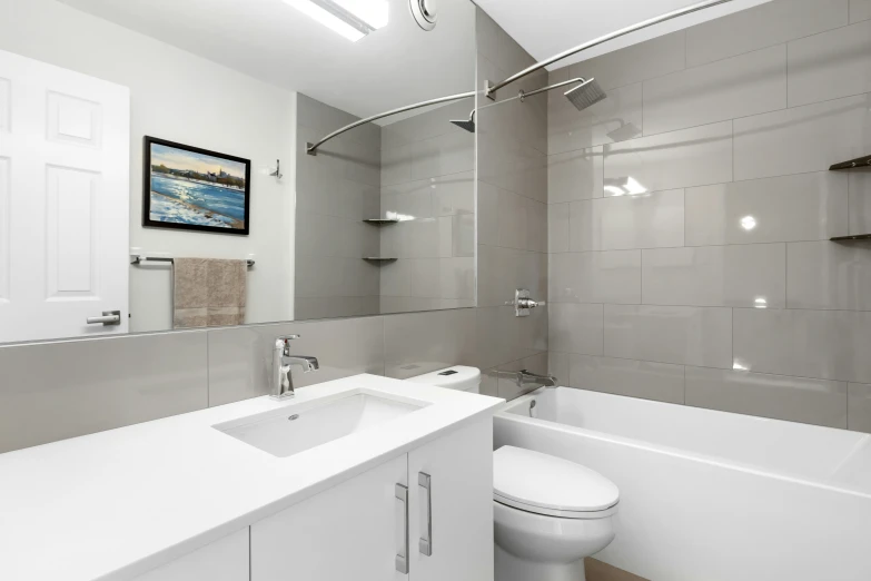 the large bathroom has white fixtures and sleek fixtures