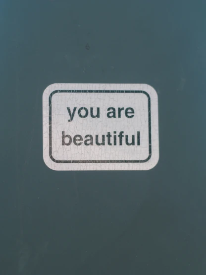 a sign that says you are beautiful over a dark background