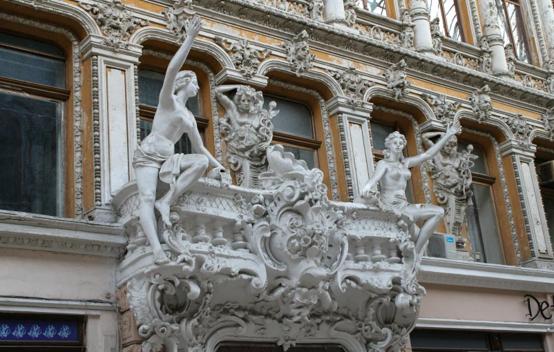 a very decorative statue in front of an old building