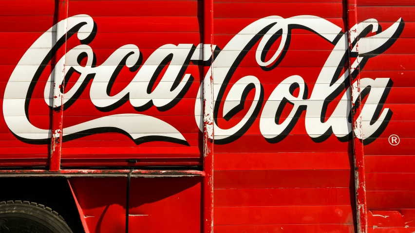 a vintage coca - cola sign painted on to a truck