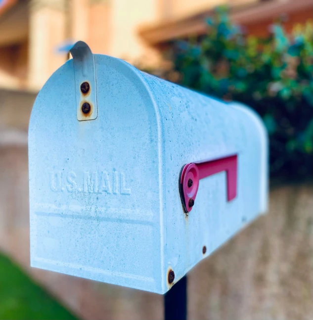 a mailbox that has one pink piece of artwork on it