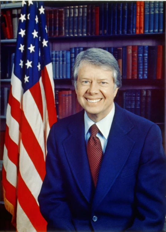 an old picture of a man in a suit next to bookshelves