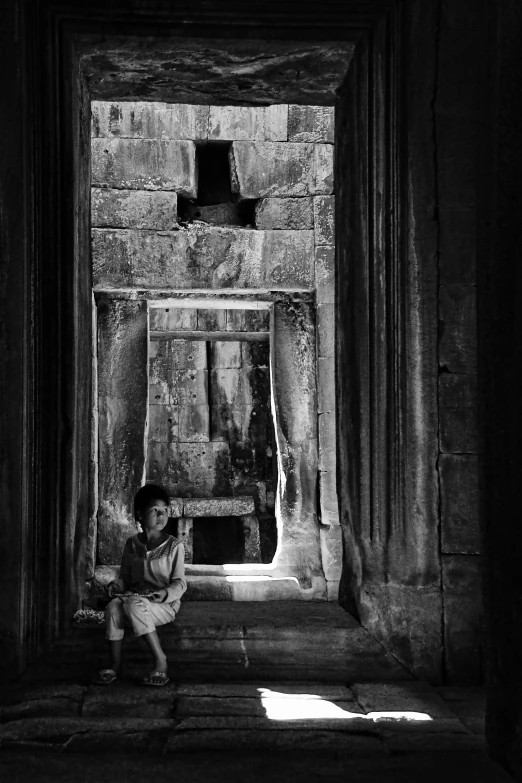 a black and white po of a woman sitting on the steps