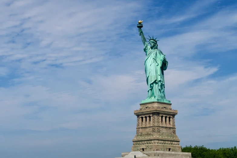 the statue of liberty is overlooking a body of water