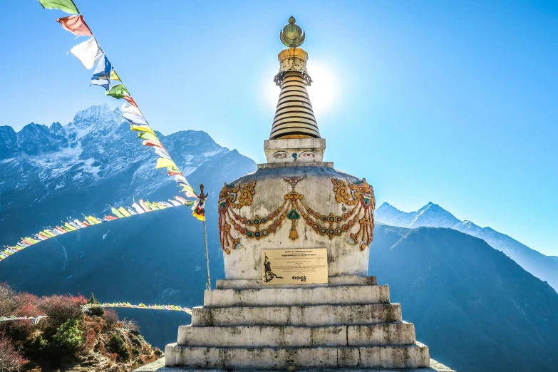 a tall ornate building surrounded by mountains