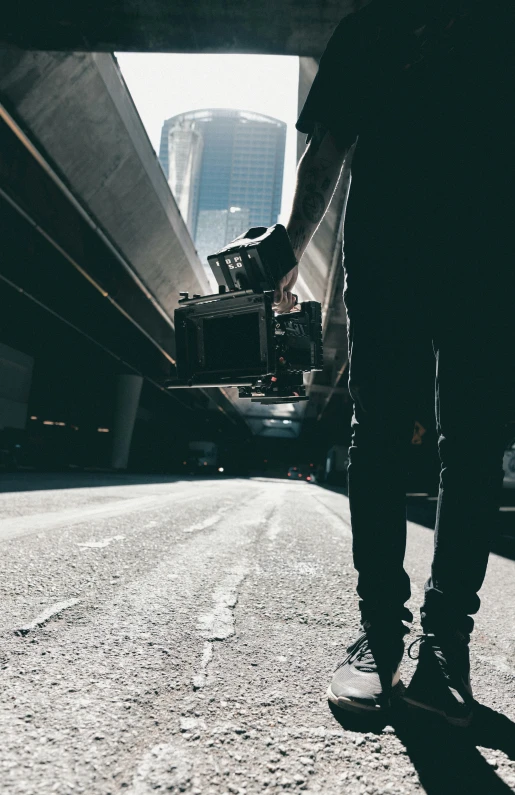 skate boarder in silhouette against the view of a freeway