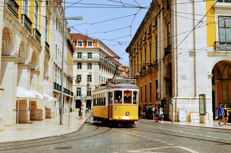 a train on a trolley going through an alley