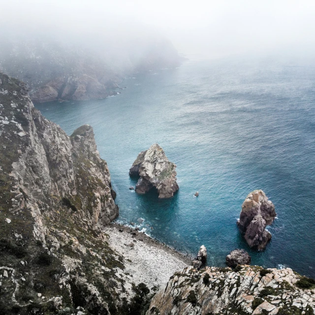 some large rocks in the middle of the ocean