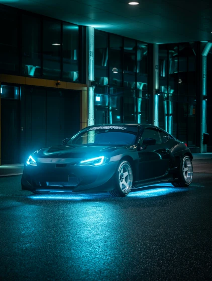 a car that is sitting in the street at night