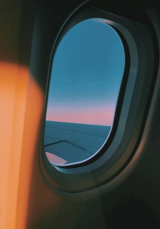 an airplane wing with the view outside the window