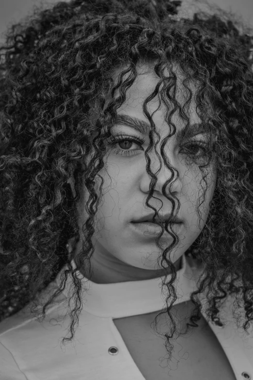 the black and white image of a woman with curly hair