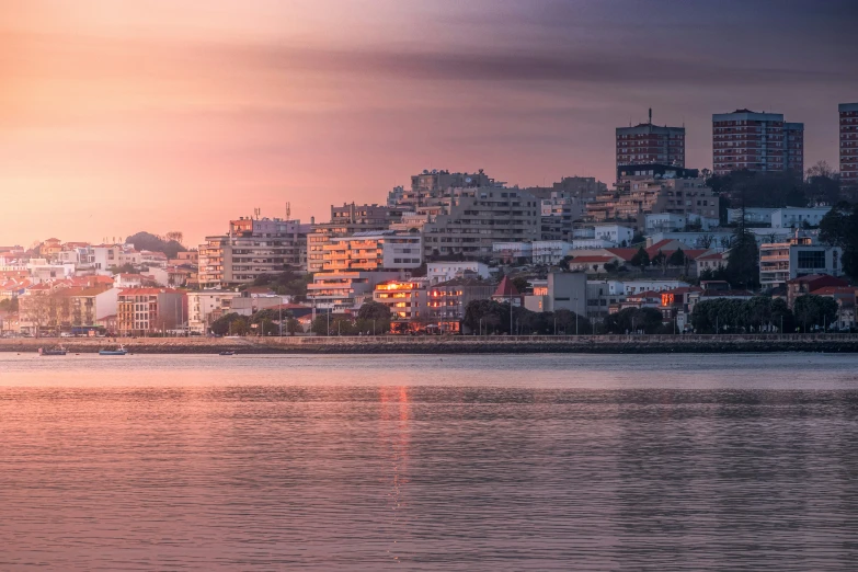 the view of a city across a bay from the beach