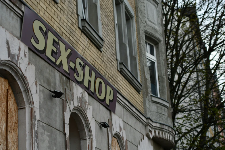 a boarded - up building with the word sexsho written on it