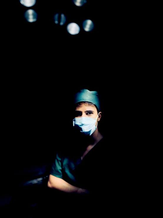 a person in medical attire standing with surgical masks on