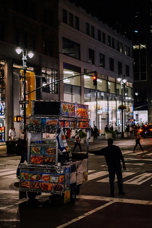 a small cart driving down a street at night