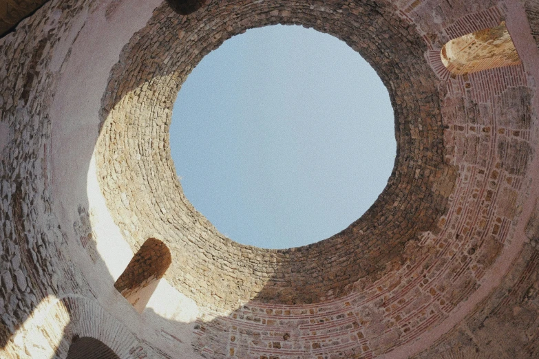 an intricate stone wall structure with sky in it