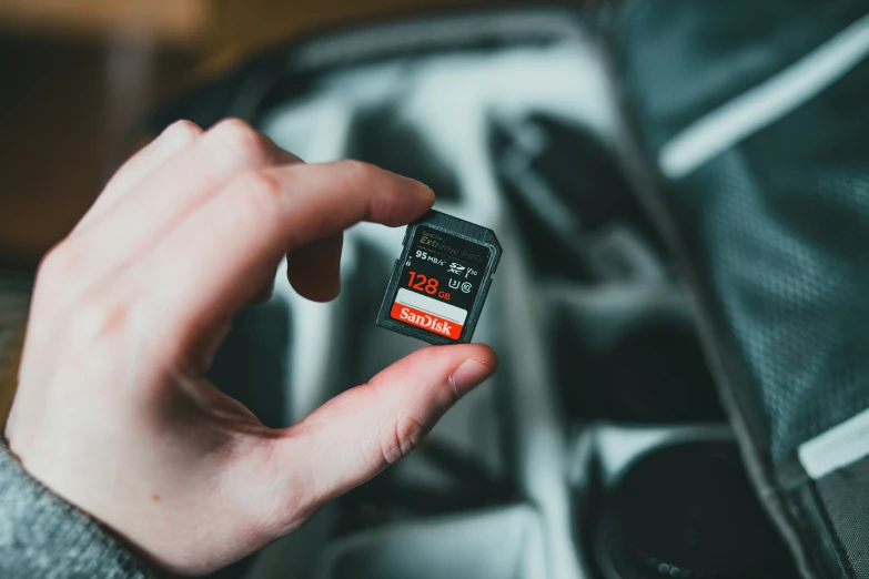 the person is holding a compact device that has an alarm on it