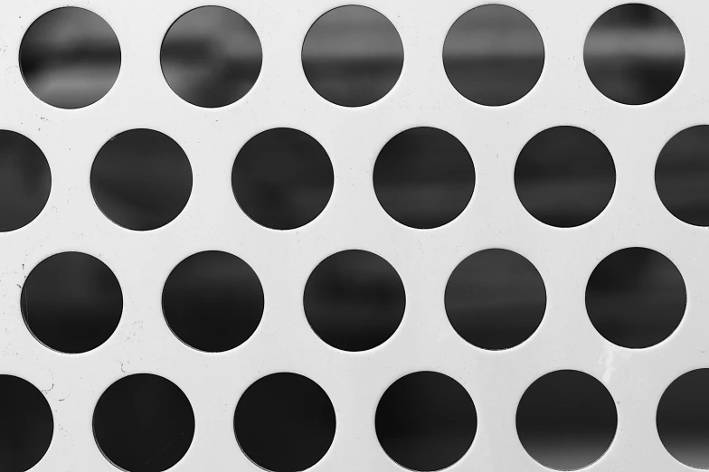 many black circles arranged on a white surface