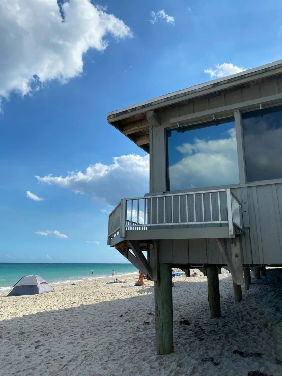 a house on the beach with a view of a blue sky