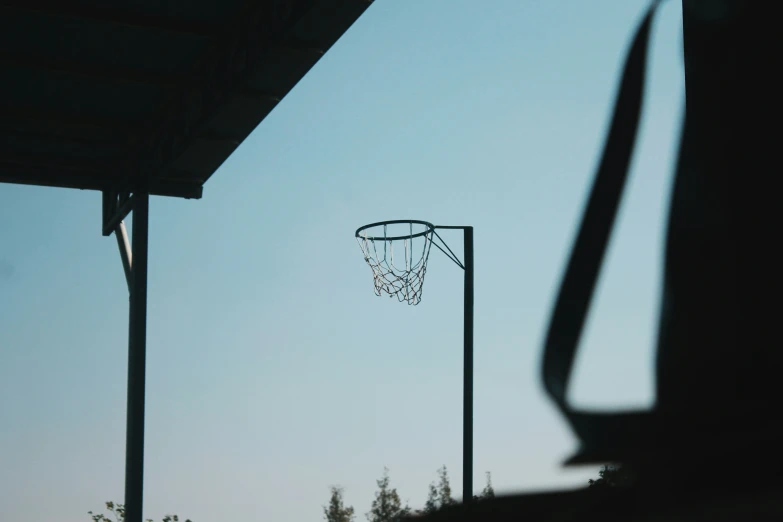 silhouettes of a basketball hoop and the remains of a hoop