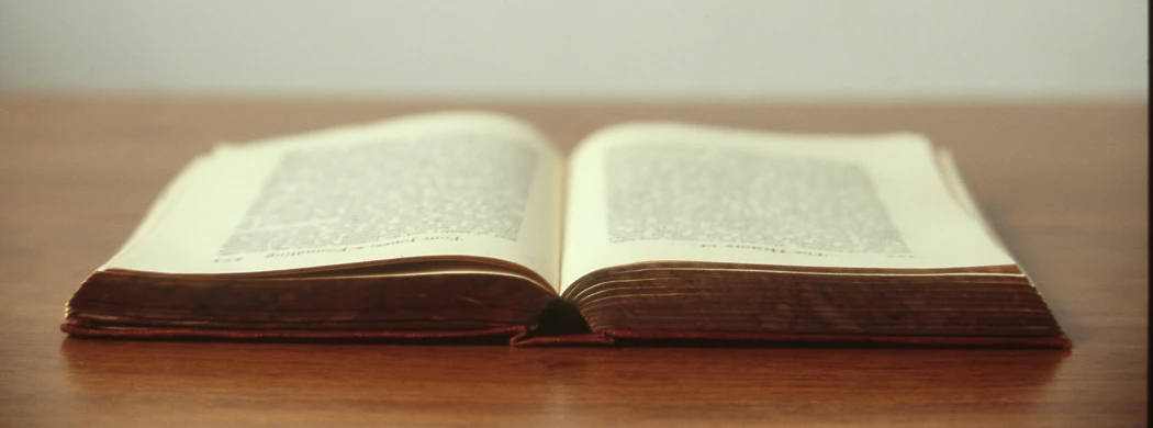 a book open on top of a wooden table