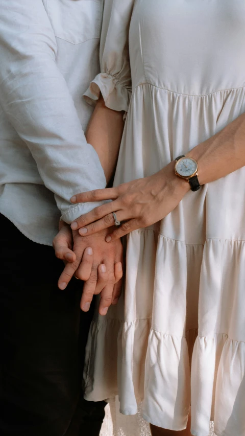 a couple holding hands in the middle of their engagement po