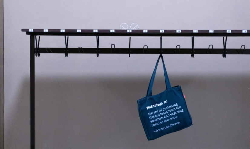 a bag hangs on a rail in a room