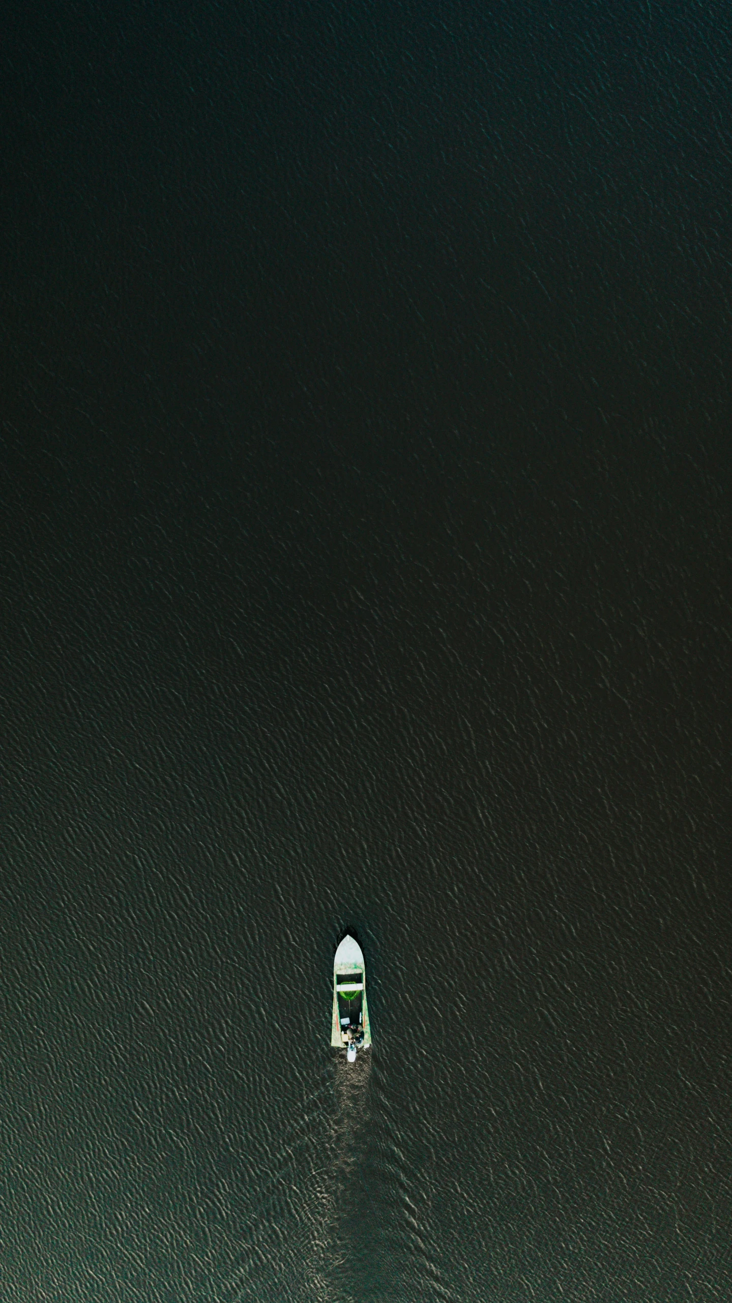 a boat floating on top of a large body of water