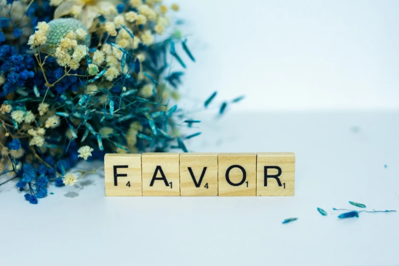 a flower and name plate next to the word favors