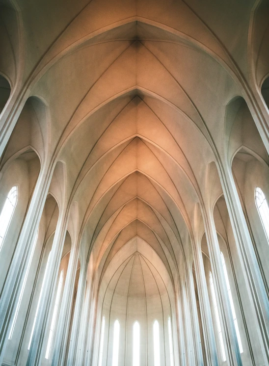 a cathedral filled with lots of tall white pillars