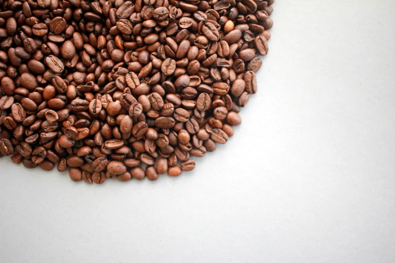 a pile of coffee beans laying on a table