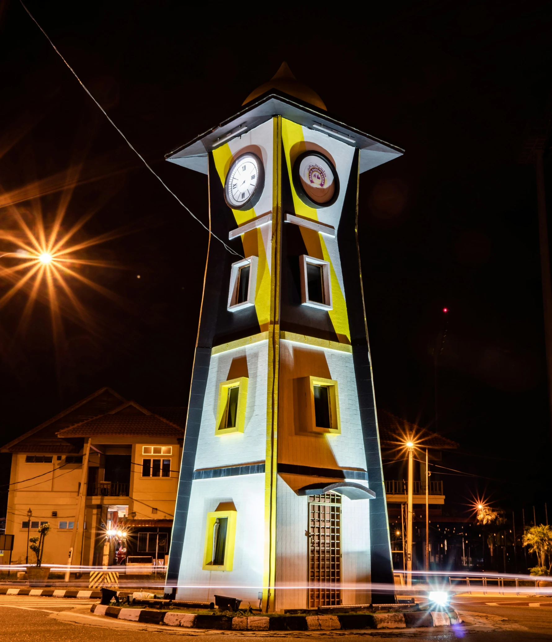 a big clock tower with a lot of lights in the sky