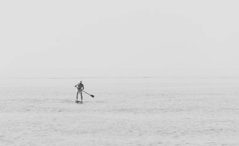 an image of man paddling on the water