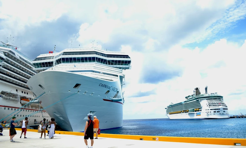 some cruise ships docked at a pier in the ocean