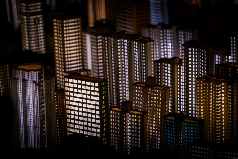 a group of tall buildings at night with lights from windows