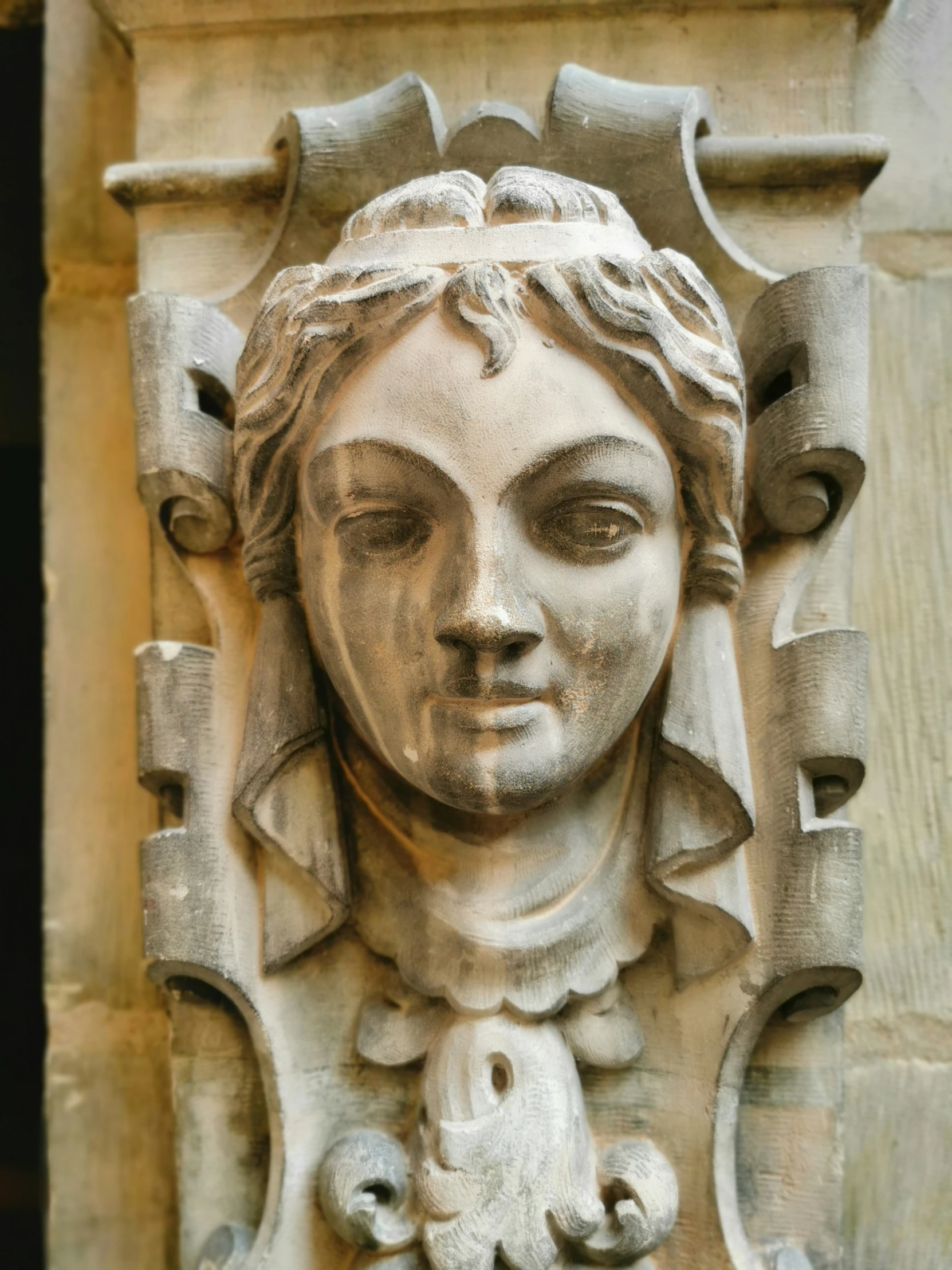 the face of an ancient sculpture with decorative decorations