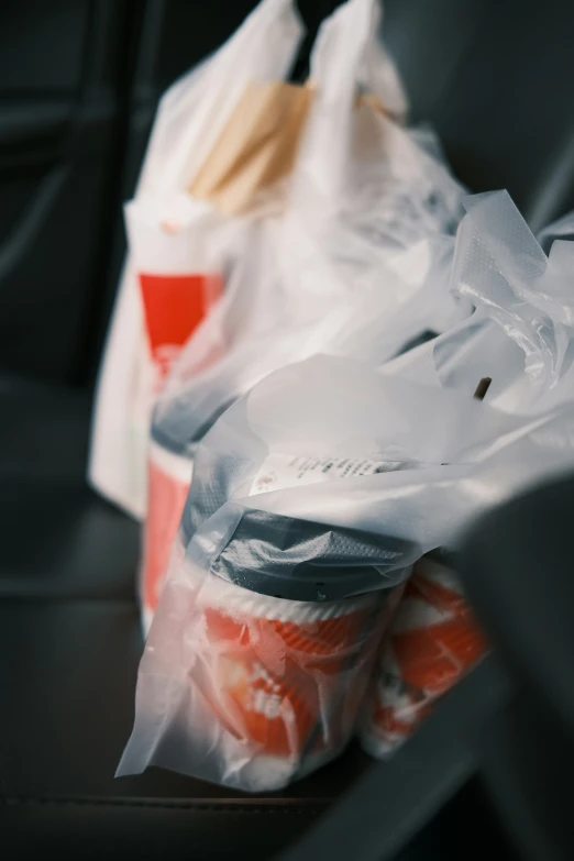 plastic bags full of food are on a chair