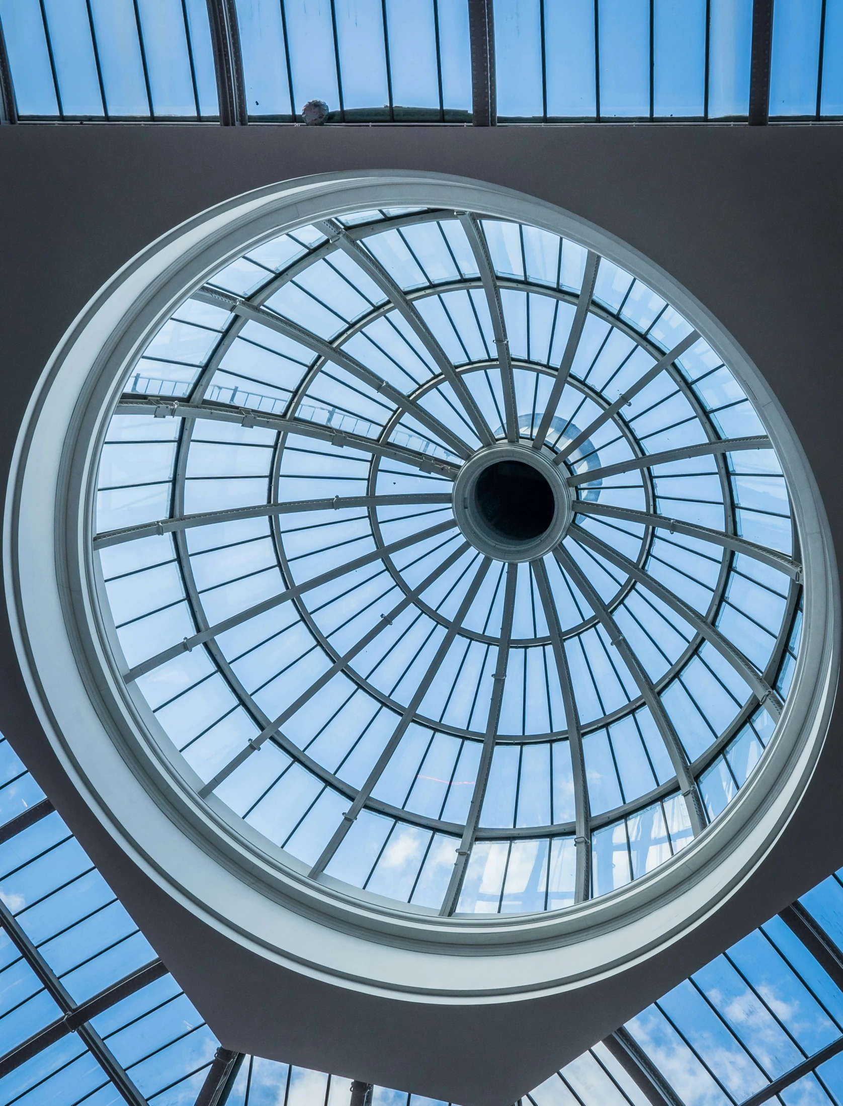 the glass ceiling and the skylights in the atrium of a building