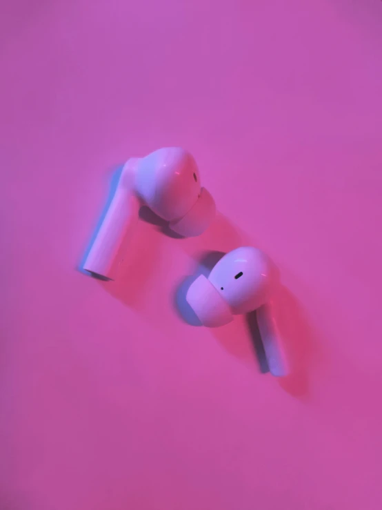 a pair of headphones with pink background