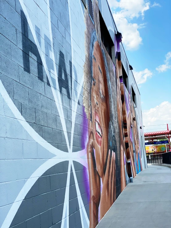 the facade of a large building with a mural on it