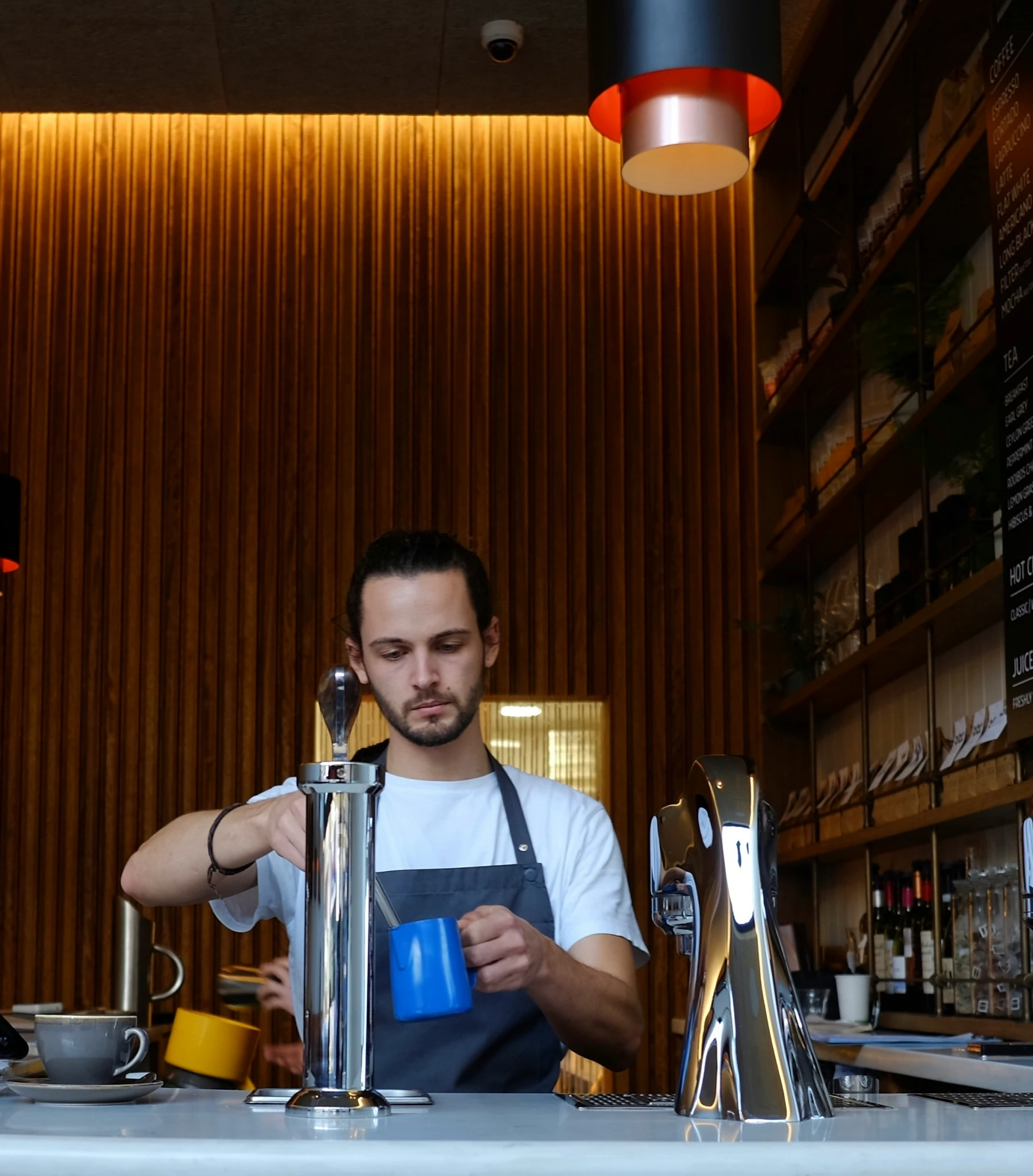 a bar worker pouring beer at his work place