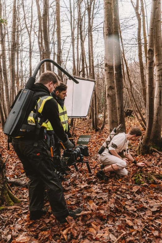 two men who are standing in the woods