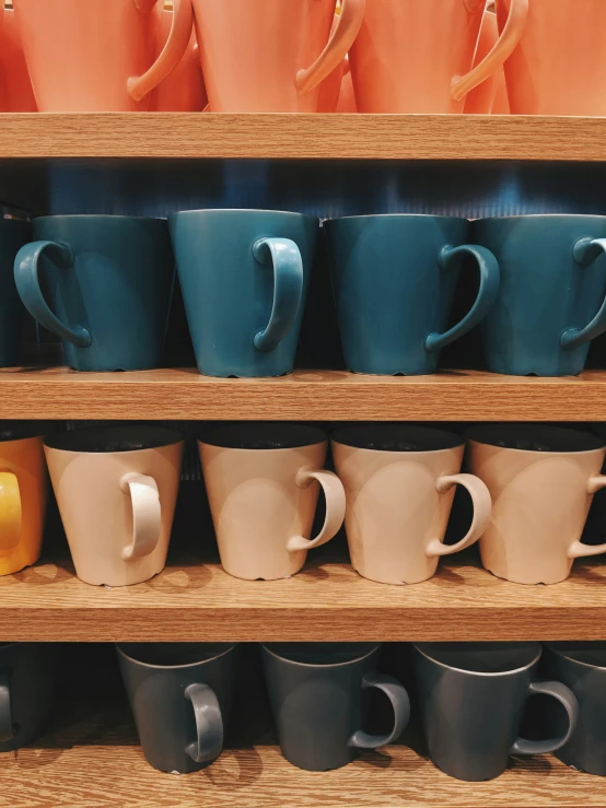 different color mugs stacked in a row next to each other